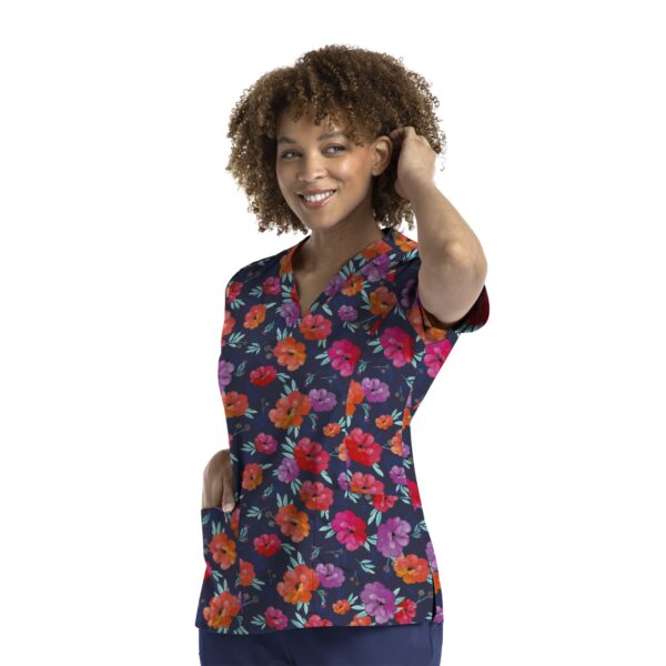 A floral printed curved V-neck top in navy featuring vibrant pink and orange flowers, with short sleeves and a pocket.