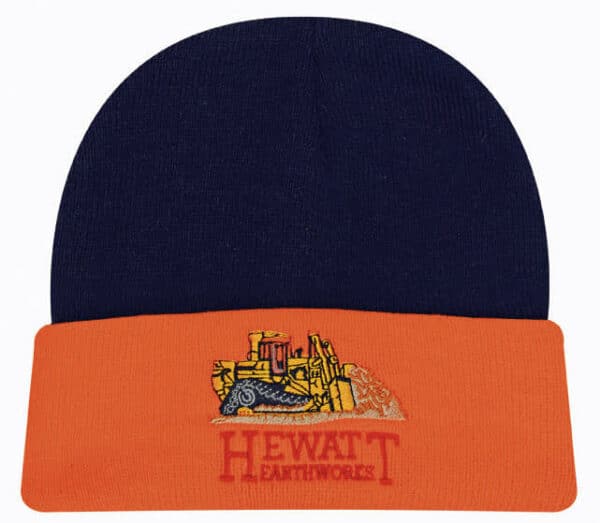 A navy and orange beanie featuring an illustration of construction equipment and a logo on the front.