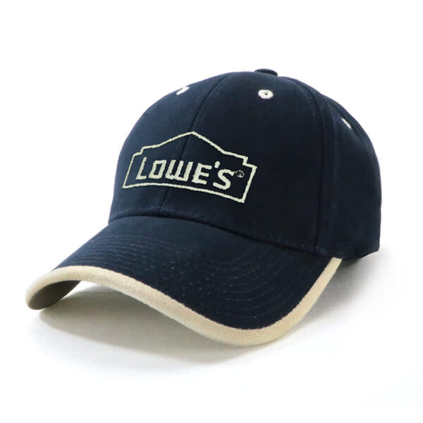 A navy cap with a beige peak and a logo on the front, featuring a classic fitted style.