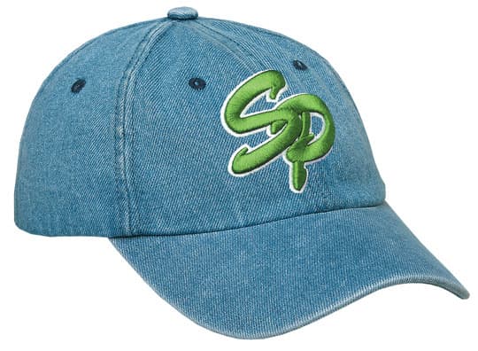 A denim blue cap featuring a green embroidered logo. The cap has a curved brim and adjustable strap.