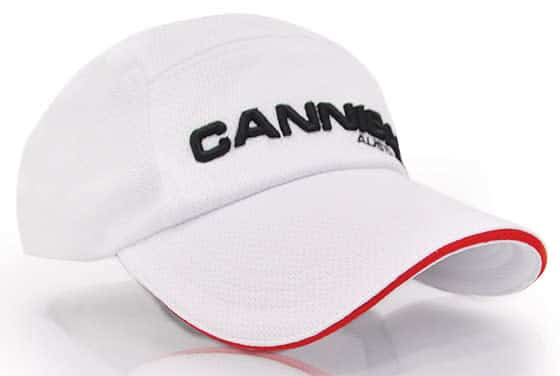 A white cap with a black logo and red detailing on the brim.