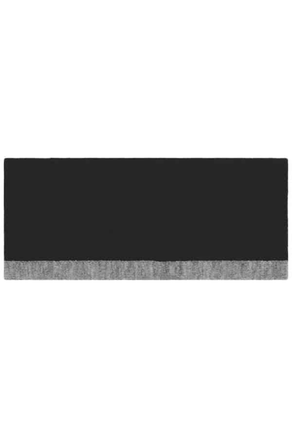 A reversible headband featuring a solid black side and a grey patterned side, with a subtle logo.