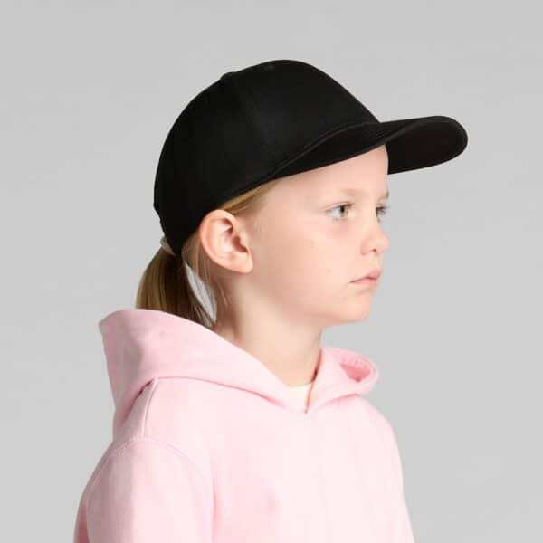 A black cap for kids, featuring a curved brim and an adjustable strap at the back, worn by a child in profile.
