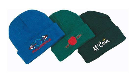 Acrylic beanies in blue, green, and dark green, each featuring different logos.