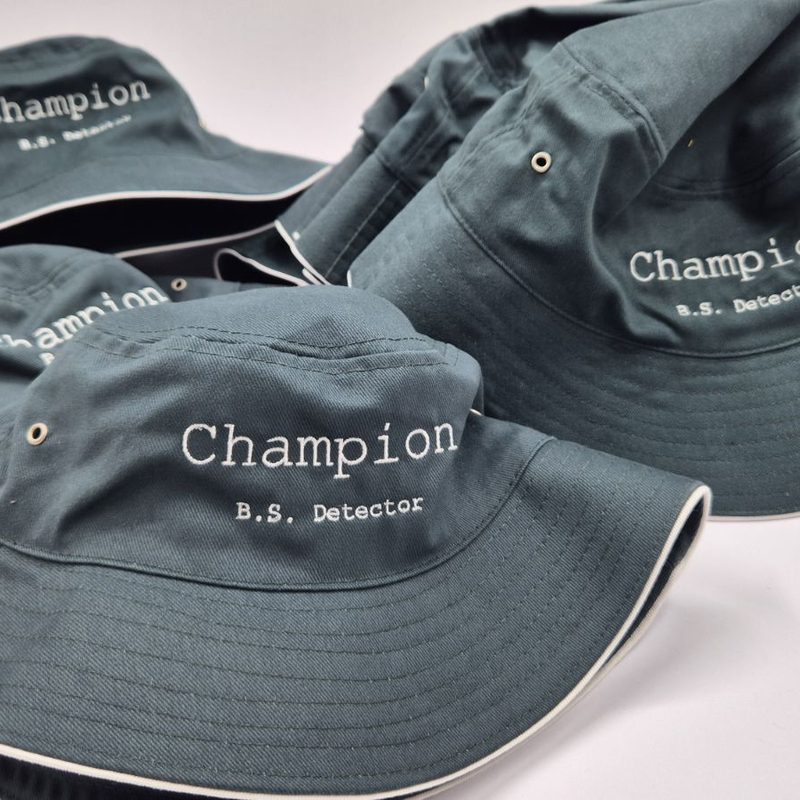 Green bucket hats with white embroidered text on the front